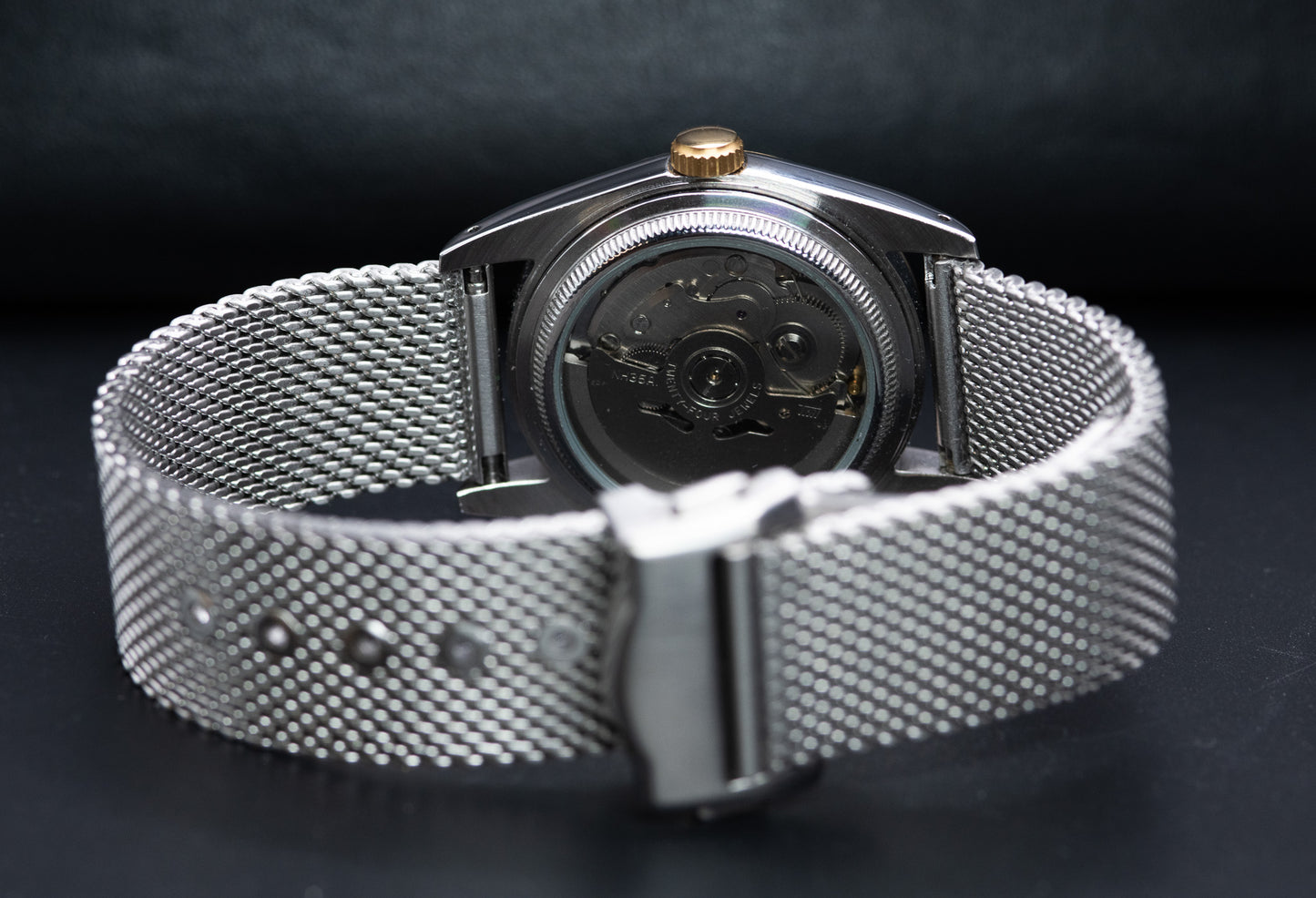 Two Tone fluted bezel watch in vintage style case. two tone fluted dial. drilled lugs. stainless steel mesh bracelet
